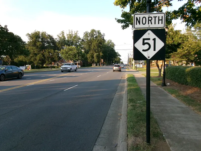 NC 51 heading north through Mint Hill past tree-lined lawns